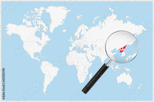 Magnifying glass showing a map of North Korea on a world map.