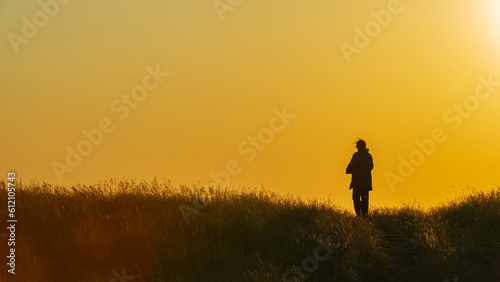 Silhouette of a running woman at sunset.