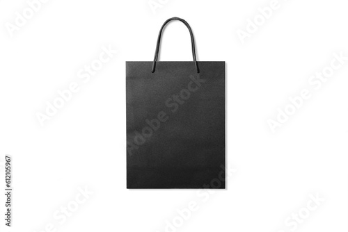 Black kraft paper shopping bag with handles isolated on a transparent background, PNG. High resolution.
