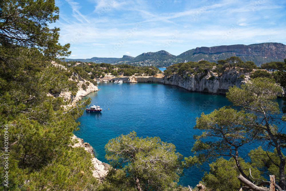 Spectacular view of  Calanque de Port-Miou with mooring ship and Canaille cape at background. Calanques National Park, Cassis, France. Travel, nature, environment, beautiful landscape concepts.