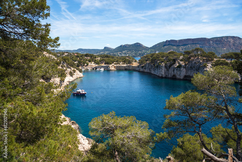 Spectacular view of Calanque de Port-Miou with mooring ship and Canaille cape at background. Calanques National Park, Cassis, France. Travel, nature, environment, beautiful landscape concepts.