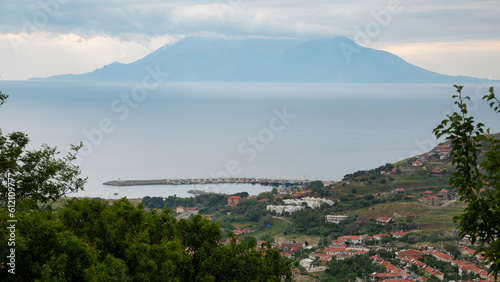 Samothrace Island and Kalekoy port view from Eski Bademli-Gliki village in Gokceada on a rainy day. Canakkale, Turkey