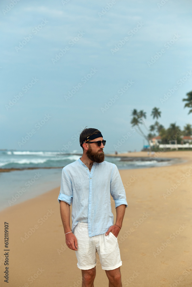 Portrait of handsome bearded man in shirt on the beach Portrait of handsome bearded man in shirt on the beach