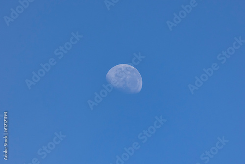 The waning moon in a blue sky. Nature. Astronomy