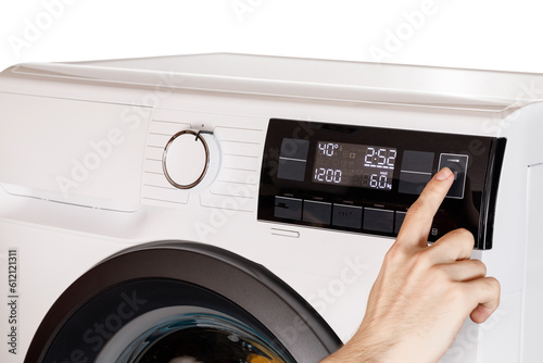 The hand select settings for laundry on modern digital display. Close-up view of automatic washing machine with touch screen on control panel. Press start or pause