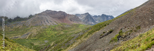 Panoramic mountain wilderness seen arctic Canada during summer time in Tombstone Territorial Park on Grizzly Lake hike expansive wild views panorama. © Scalia Media