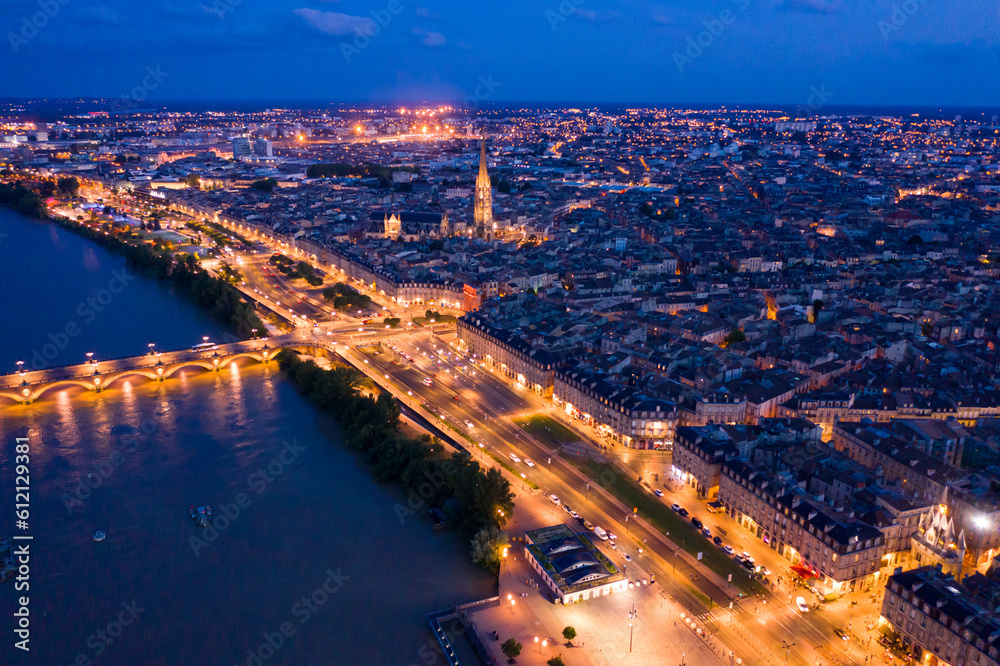 Panoramic aerial view of illuminated Bordeaux city on Garonne river at night