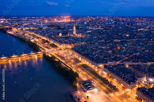 Panoramic aerial view of illuminated Bordeaux city on Garonne river at night