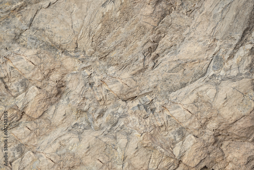 Rock texture. Light brown gray beige stone granite background. Rough cracked mountain surface. Close-up. Solid. Natural.