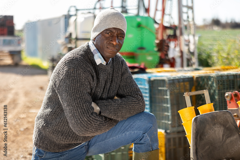 Portrait of male tractor driver in farm backyard