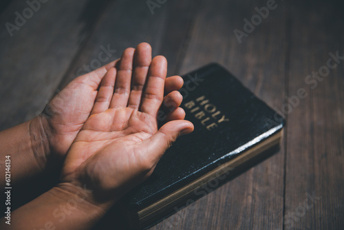 Christian life crisis prayer to god. Woman pray for god blessing to wishing have a better life. Female hands praying to god with the bible. begging for forgiveness and believe in goodness.