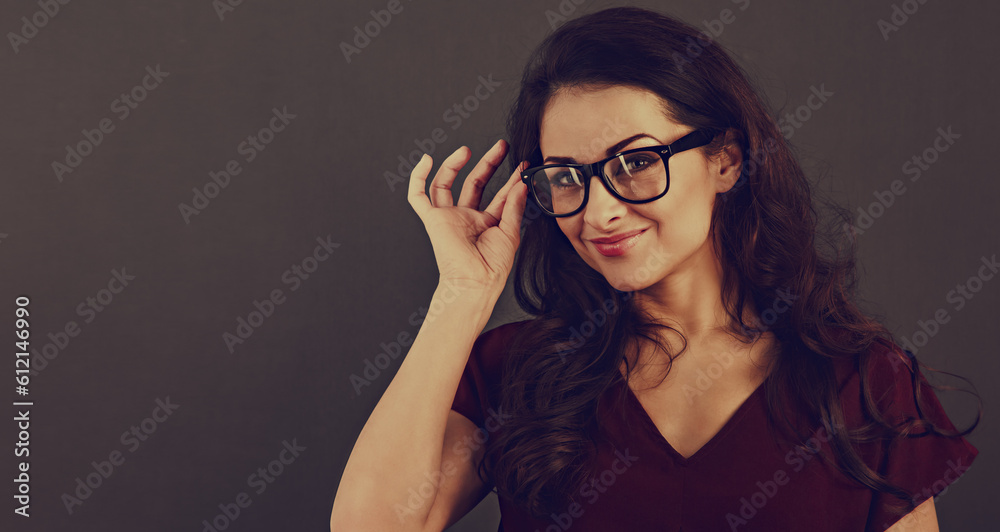 Beautiful thinking happy brunette business woman looking happy in eye glasses and holding spectacles on toned background with empty copy space. Closeup front view studio portrait. Beautiful thinking happy brunette business woman looking happy in eye glasses and holding spectacles on toned background with empty copy space. Closeup front view studio portrait.