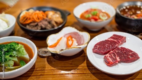 Korean BBQ set. Beef for grill on stove serve with vegetable and soup wood table , Japanese food style barbecue - generative ai