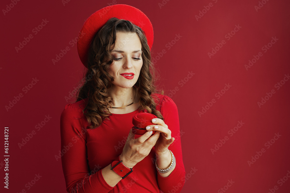curious elegant woman isolated on red background curious elegant woman isolated on red background