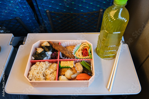 Japanese Eki Bento and a bottle of green tea on a Shinkansen Train in Japan. photo