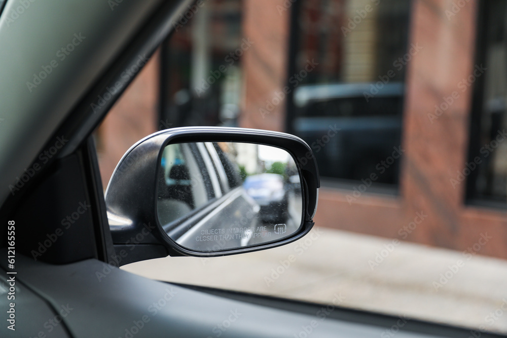 A car mirror reflects the journey ahead, symbolizing self-reflection, perspective, awareness, and the constant pursuit of progress A car mirror reflects the journey ahead, symbolizing self-reflection, perspective, awareness, and the constant pursuit of progress