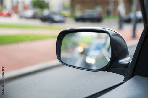 A car mirror reflects the journey ahead, symbolizing self-reflection, perspective, awareness, and the constant pursuit of progress © Your Hand Please