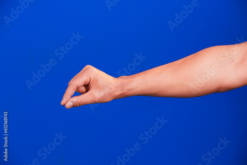 Human hand on a blue background. © serg3d