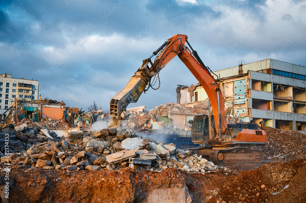 Excavator with hydraulic chews breaks beam of concrete Excavator with hydraulic chews breaks beam of concrete