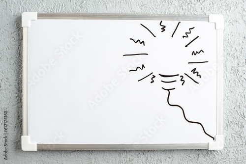 Top view of incompletely drawn thing on white desk on gray sand background photo