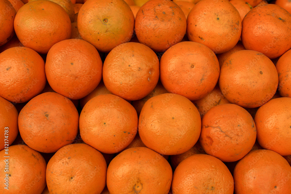 Orange fruit background. Close-up of oranges on a market