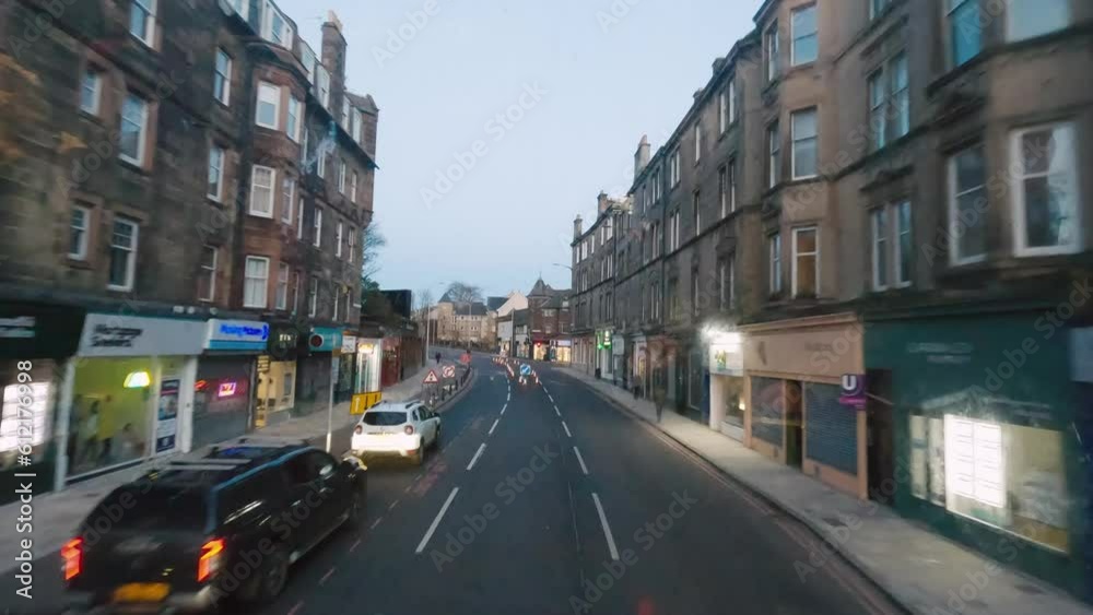 Magical sunset ride through the charming streets of Edinburgh aboard a double-decker bus, immersing in the city's vibrant atmosphere Magical sunset ride through the charming streets of Edinburgh aboard a double-decker bus, immersing in the city's vibrant atmosphere