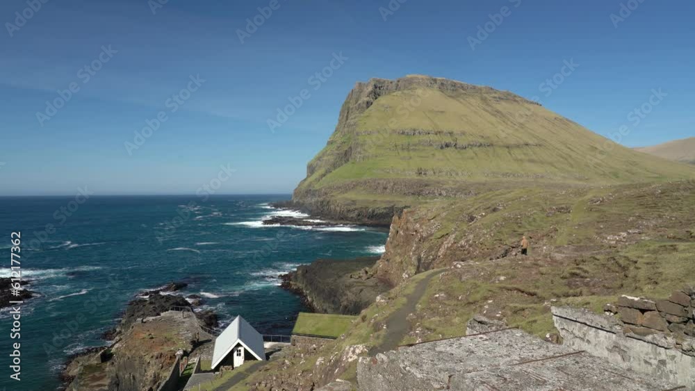 Rocky Coastline Of Hvalba Village In The Northeast Of Suduroy In The Faroe Islands. - wide panning Rocky Coastline Of Hvalba Village In The Northeast Of Suduroy In The Faroe Islands. - wide panning