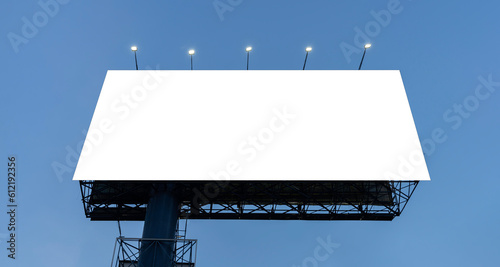 A large mockup of a blank white billboard or white promotional poster appears on the outdoors against a blue sky background.