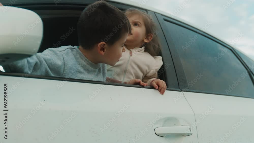 Curious funny little kids looking outside of a car window. Roadtrip or travel. Curious funny little kids looking outside of a car window. Roadtrip or travel.