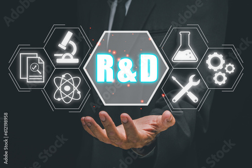 R&D, Research and development concept, Business person hand holding esearch and development icon on virtual screen. photo