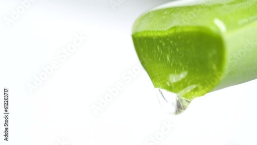 Macro transparent aloe vera cream texture, serum gel cosmetic mask on green leaf