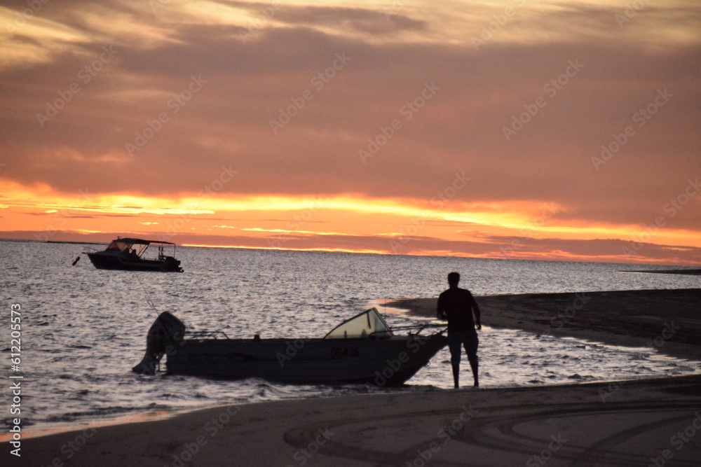 Fototapeta premium Boat and man at sunset