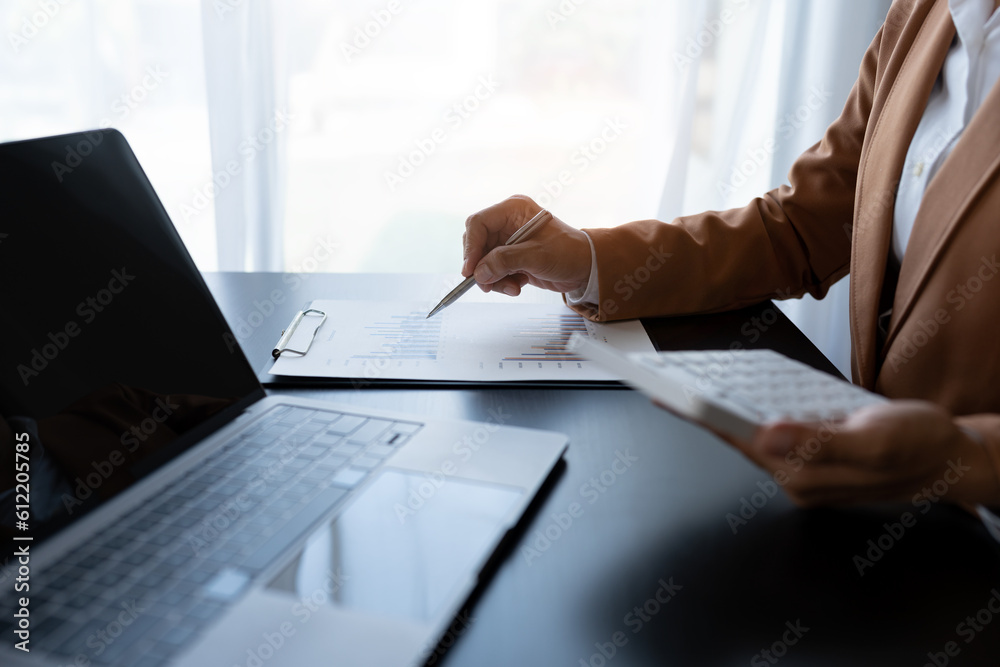 Businesswoman analyzing income charts and graphs with laptop computer. business analysis and strategy concept Business statistics, profit, financial growth rate on graph paper. financial data chart Businesswoman analyzing income charts and graphs with laptop computer. business analysis and strategy concept Business statistics, profit, financial growth rate on graph paper. financial data chart