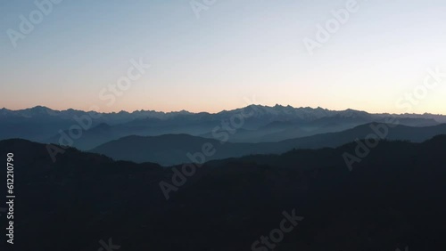 Silhouettes Of Mountain Ranges During Sunrise In Sangla Valley, Himachal Pradesh India. Aerial Wide Shot photo