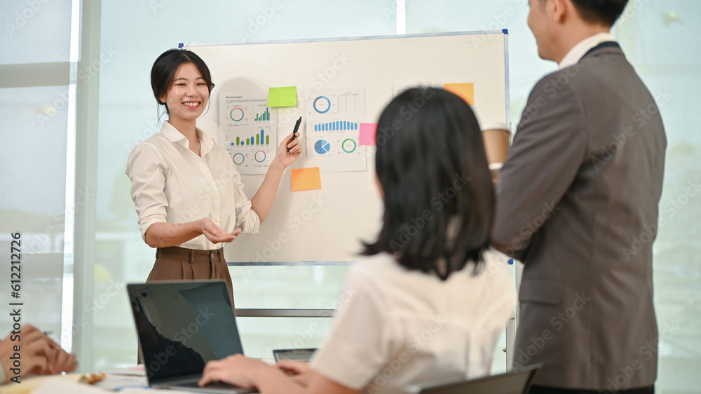 A female financial assistant is presenting a new financial investment plan in the meeting. A female financial assistant is presenting a new financial investment plan in the meeting.