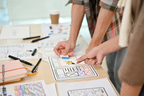 A close-up image of a team of professional graphic designers and developers in a meeting