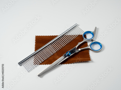 Scissors and comb for grooming dogs. Dog grooming kit. Close-up of a dog grooming tool.