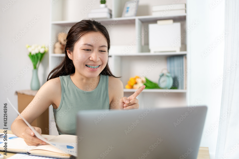 Asian student chatting or exchanging knowledge through laptop video call, Education through wireless education system, Conversations with teachers and classmates, Online learning, Study at home. Asian student chatting or exchanging knowledge through laptop video call, Education through wireless education system, Conversations with teachers and classmates, Online learning, Study at home.
