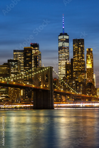 New York City skyline of Manhattan with Brooklyn Bridge and World Trade Center skyscraper at twilight portrait format in the United States © Markus Mainka
