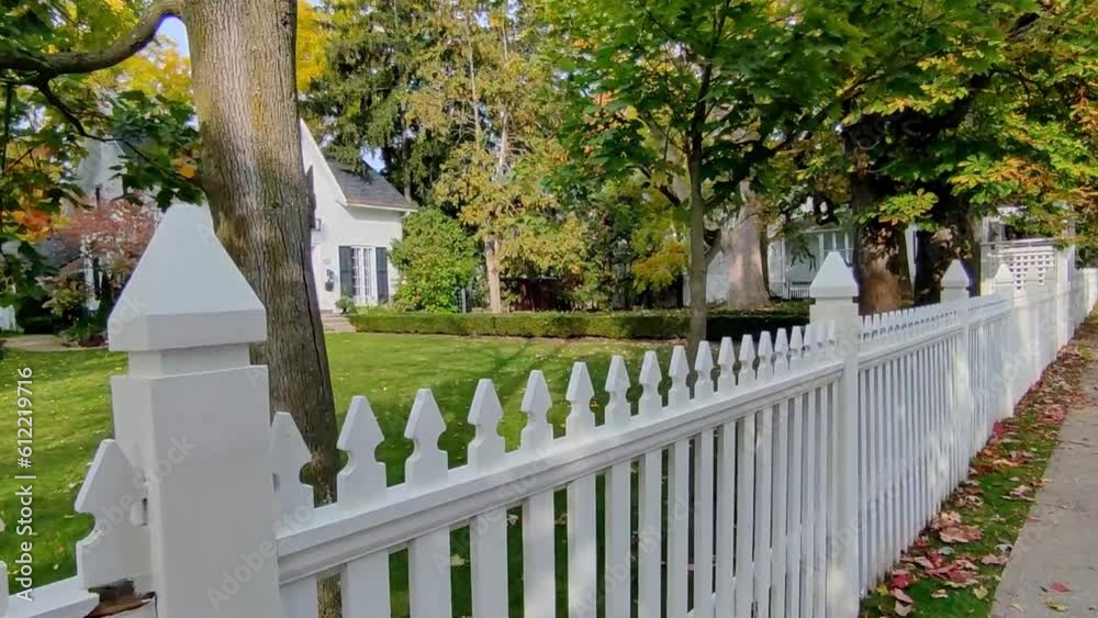 View of a small town in Canada with white picket fence in autumn View of a small town in Canada with white picket fence in autumn
