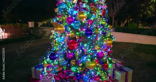 Illuminated Christmas tree with ribbon decorations in the dark in Beverly Hills, Los Angeles, California, 4K