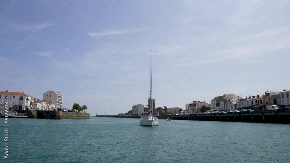 Tall mast sailboat yacht entering the port from the Atlantic ocean at Les Sables D'olonne Western France, View from boat Tall mast sailboat yacht entering the port from the Atlantic ocean at Les Sables D'olonne Western France, View from boat