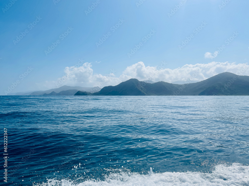 Beautiful seascape on the Caribbean coast of Venezuela. in the background mountains. Big waves. Very sunny and slightly cloudy day. selective focus
