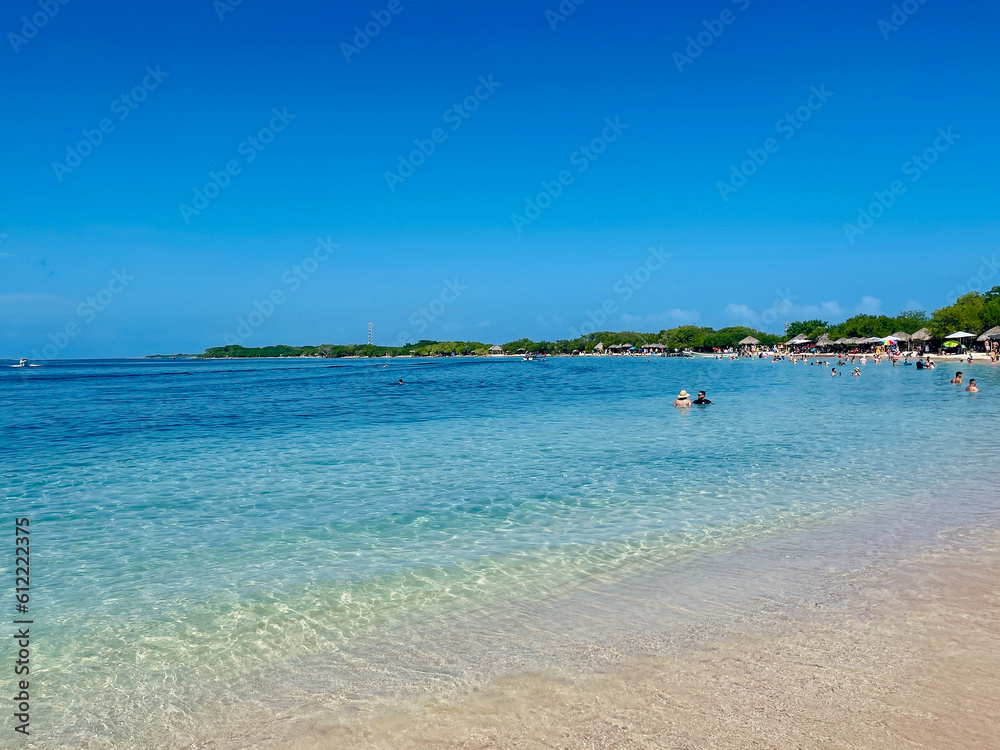 Beautiful Caribbean Beach in Venezuela Isla Larga. Beach full of tourists. very sunny day.Tourism and vacation concept. selective focus Beautiful Caribbean Beach in Venezuela Isla Larga. Beach full of tourists. very sunny day.Tourism and vacation concept. selective focus