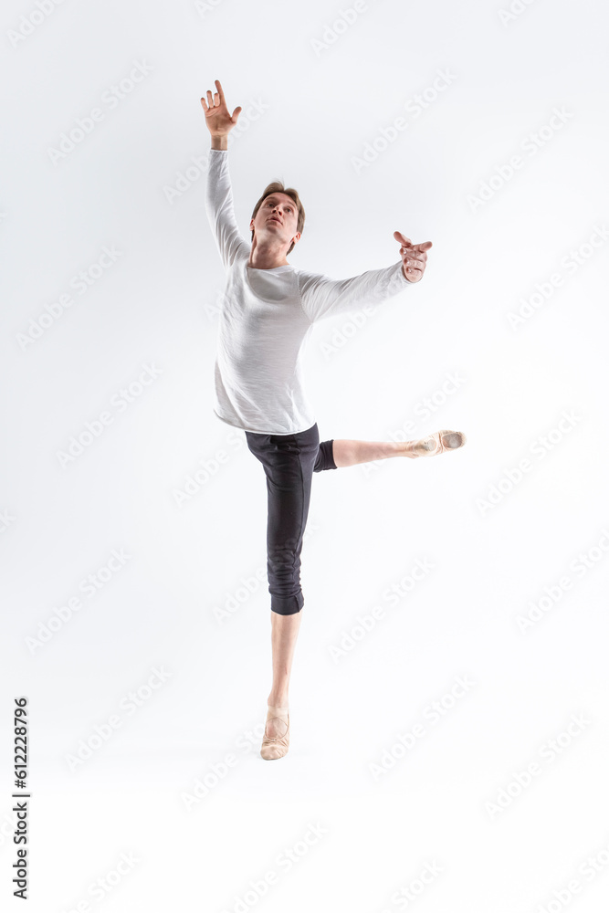 Portrait of Caucasian Young, Handsome Sporty Athletic Ballet Dancer with Lifted Hand Over White.