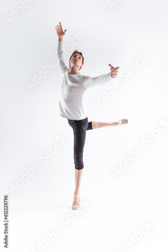 Portrait of Caucasian Young, Handsome Sporty Athletic Ballet Dancer with Lifted Hand Over White.