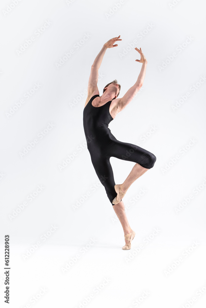 Professional Ballet Dancer Young Athletic Man in Black Suit Posing in Ballanced Dance Pose Studio On White.