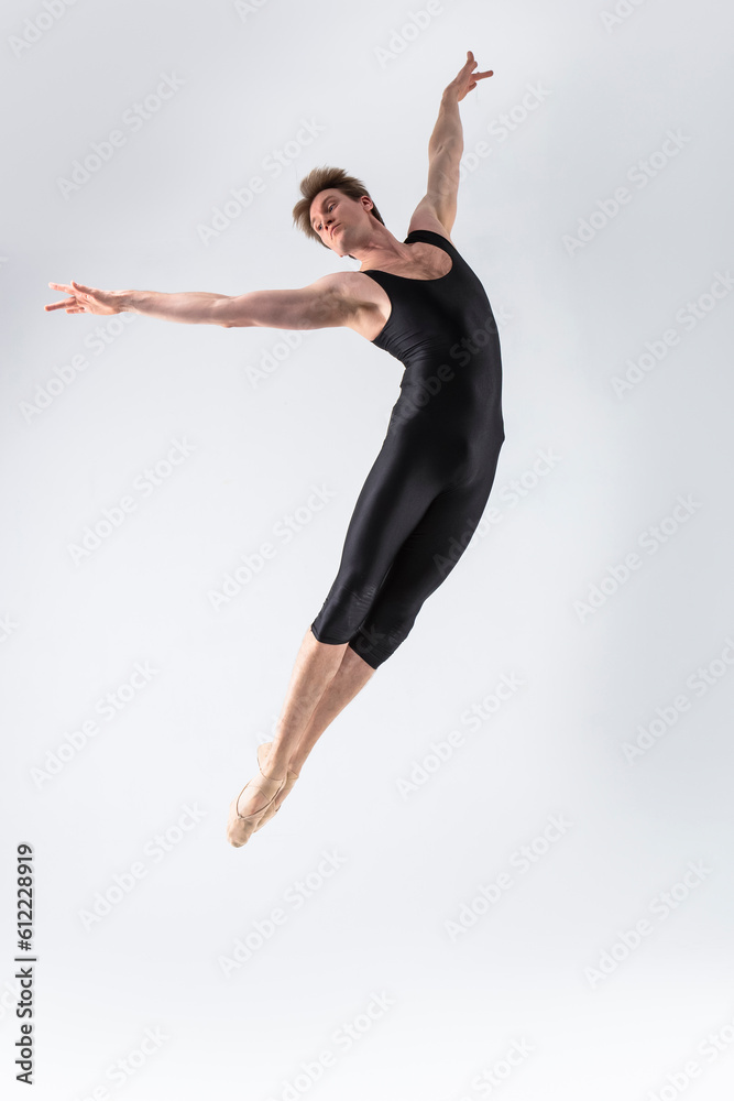 Ballet Dancer Young Man in Black Dance Suit Posing in Flying Ballanced Dance Pose Studio On White.