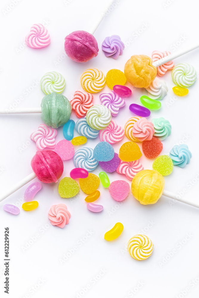 Sweet lollipops and candies on white background