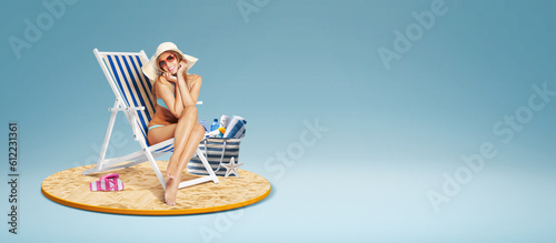 Attractive woman sitting on a deckchair on the beach © stokkete